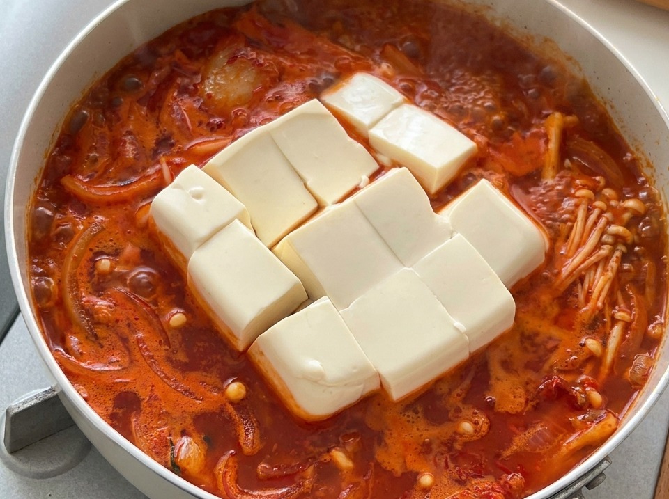 뜨겁게 끓고 있는 한국식 김치찌개 안에 들어 있는 큼직한 순두부 조각들.
