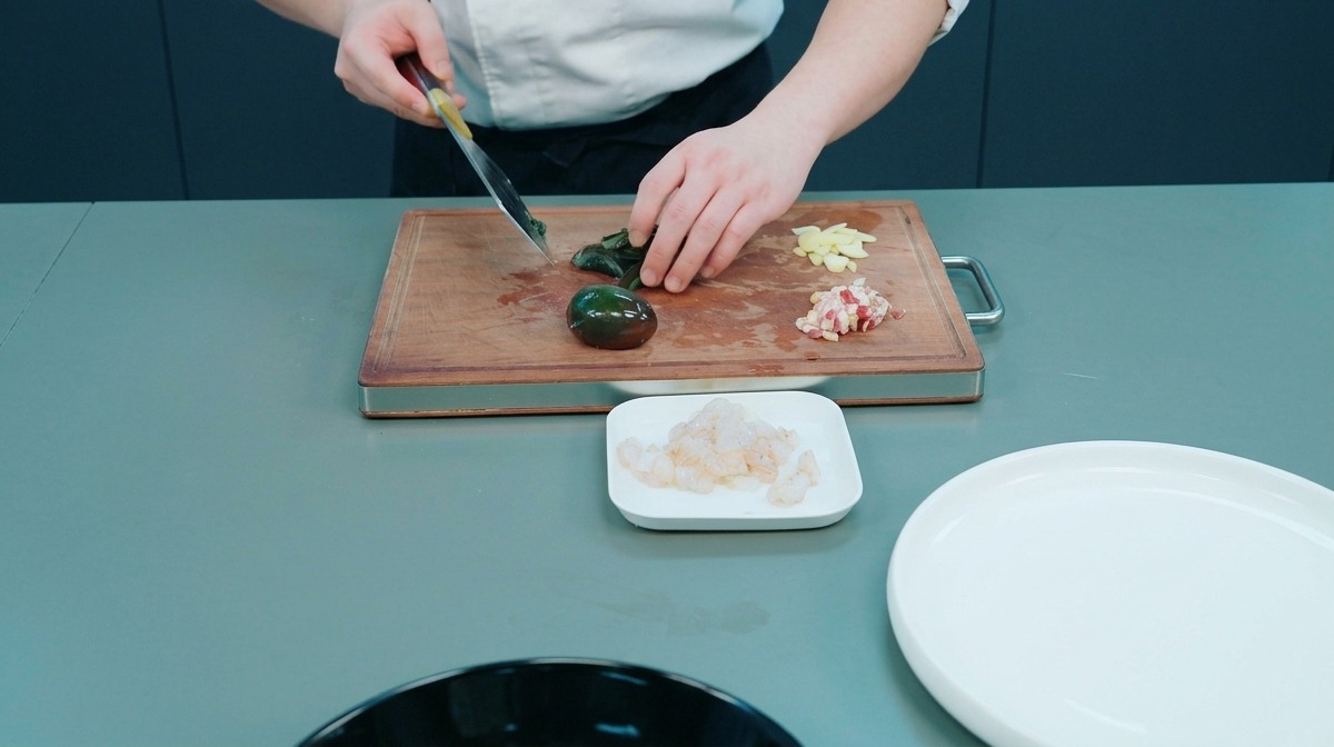 도마 위에서 피단과 마늘을 다지는 모습
