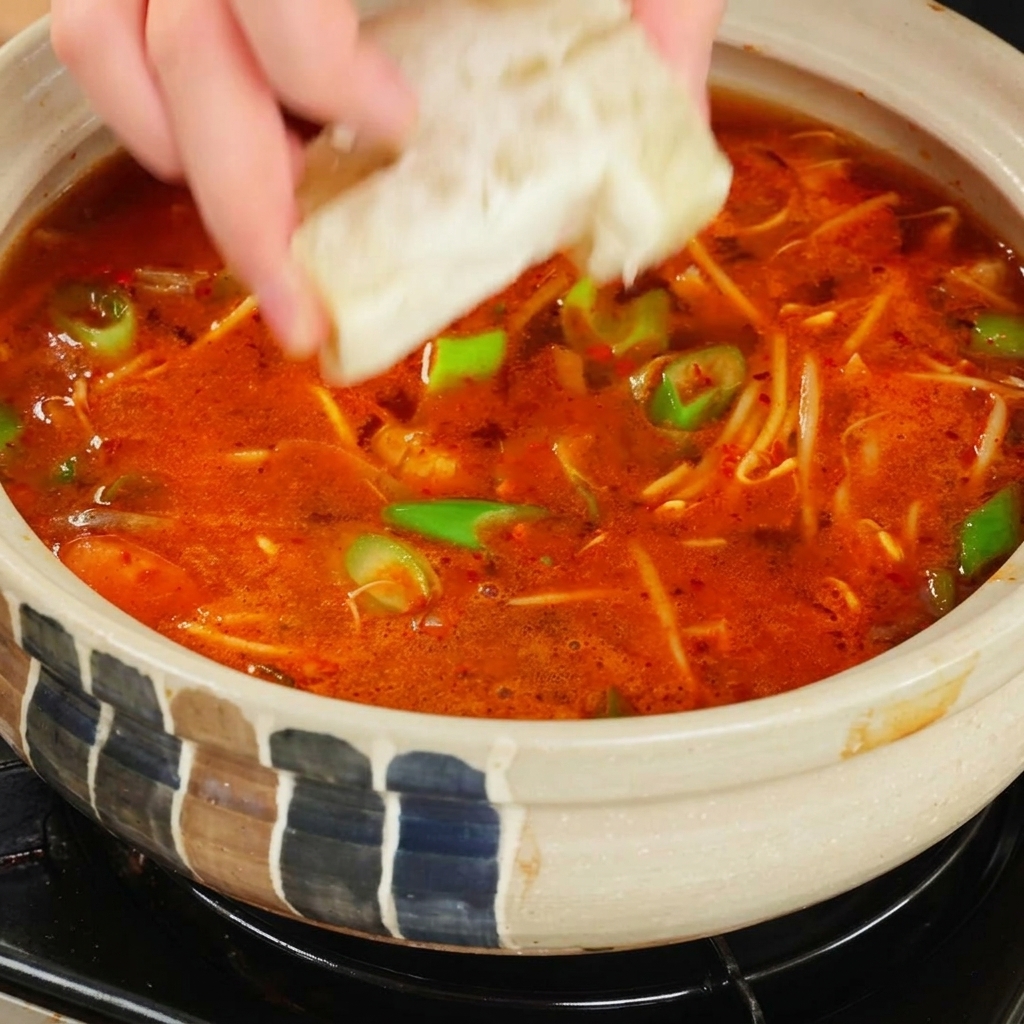 국물에 치킨스톡 큐브를 넣는 모습