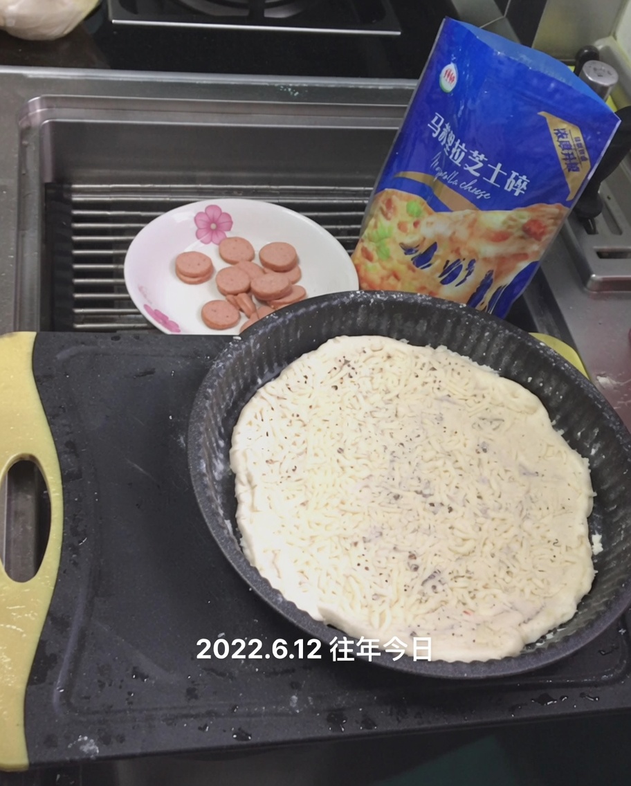 소스 위에 모짜렐라 치즈를 뿌리는 모습