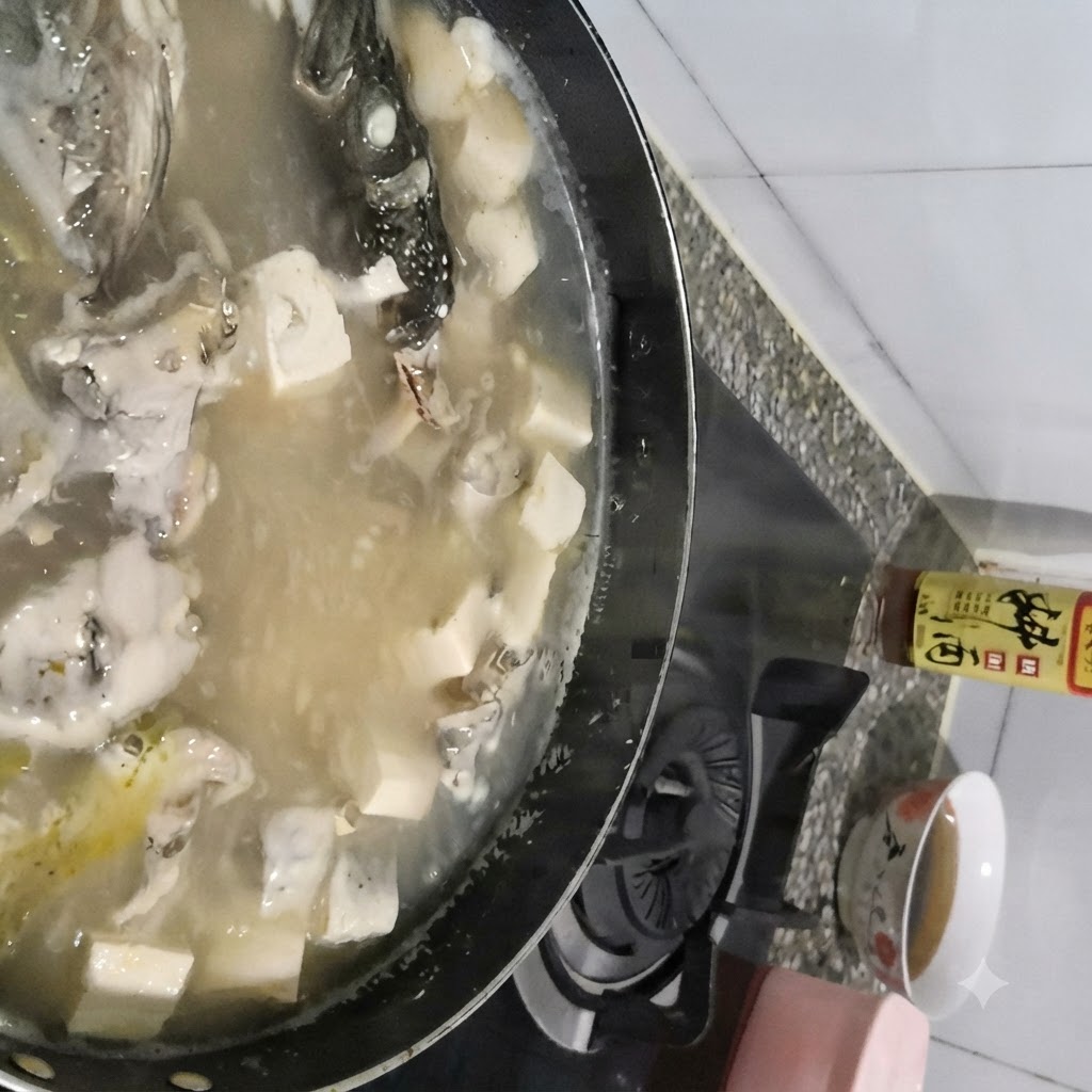 숟가락으로 보글보글 끓는 명태 두부국 표면의 거품을 걷어내고 있는 모습.