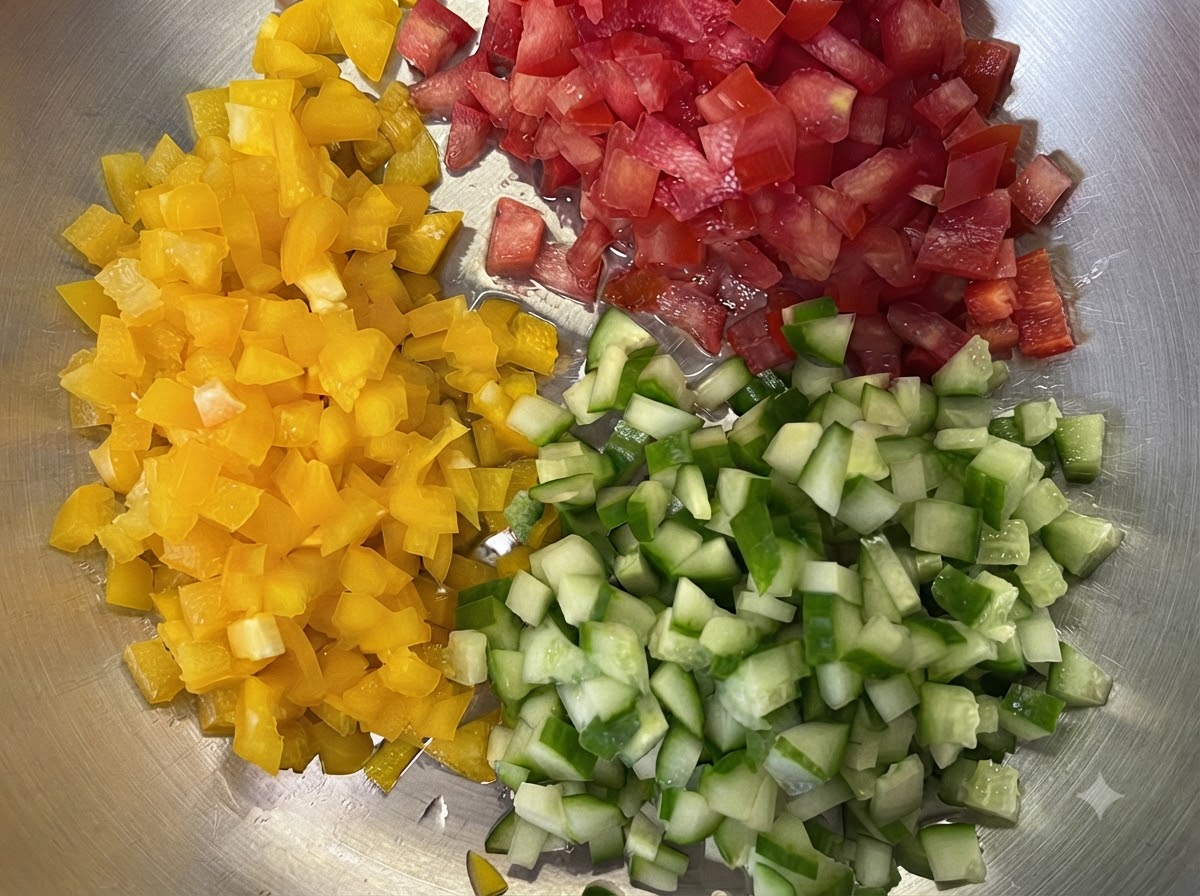 노란 파프리카, 빨간 토마토, 초록 오이가 트레이 위에서 작은 주사위 모양으로 잘게 썰려 있는 모습
